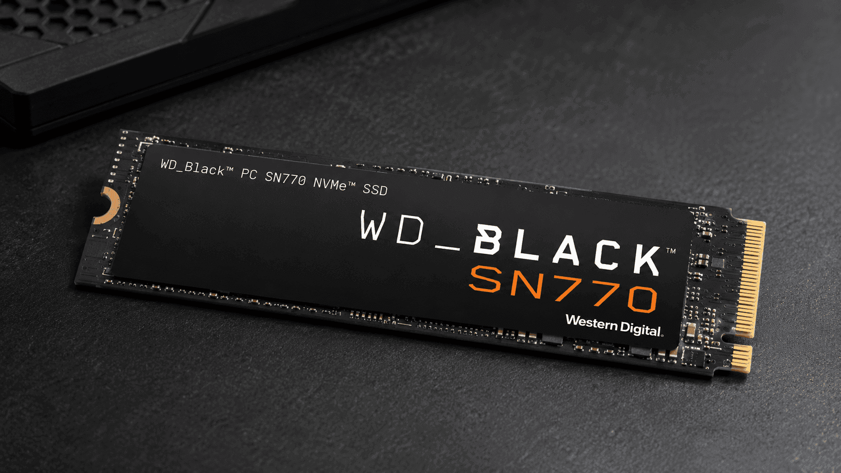 Amazon Renewed WD_BLACK SN770 2TB NVMe SSD installed on gaming PC motherboard with heatsink visible